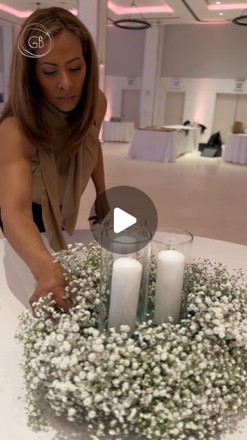 Flowers 🌺 By G Bella- Wedding Stylist|Floral Designer on Instagram: "Remember those gorgeous baby’s breath table runner arrangements we highlighted last week? Well, we’re back to talk more details from that wedding because we are simply obsessed with how it all turned out 😍  This time, we want to highlight the complimentary round table centerpieces.   We kept it more minimal for the round tables and created wreaths out of baby’s breath with candle votives inside the wreaths. These airy arrangements not only complimented the longer tables’ elaborate designs but also added an ethereal charm to the reception space.   And here’s a quick #GBellaTuesday tip for you: Putting foam in the middle of the wreaths allows the candle votives to stand out amidst the baby’s breath, creating more harmony Round Garland Centerpiece Wedding, Baby’s Breath Baby Shower Table Decor, Wreath Centerpieces Wedding, Baby’s Breathe Centerpieces, Babys Breath And Candles Centerpiece, Round Mirror Centerpiece Ideas, Table Runner For Wedding Reception, Candles And Baby’s Breath Centerpieces, How To Arrange Flowers Centerpieces