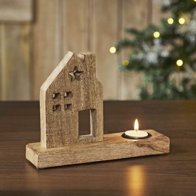 Add a touch of primitive charm to your home decor with the VHC Brands Tropical Wood Tealight Holder featuring a Wooden Saltbox House design. Crafted from tropical wood in a natural Wood Brown finish, this candle holder exudes rustic elegance and warmth, making it an ideal addition to your kitchen, dining table, entryway, or living room. The cutout saltbox house silhouette adds a quaint and cozy feel, while the star-shaped cutout on the roof enhances its rustic appeal, creating a captivating acce Rustic Wooden Christmas Decor, 4x6 Wood Projects, Christmas Woodworking Projects, Woodworking Candle Holder, Wood Tea Light Holder, Saltbox House, House Silhouette, Saltbox Houses, Table Entryway