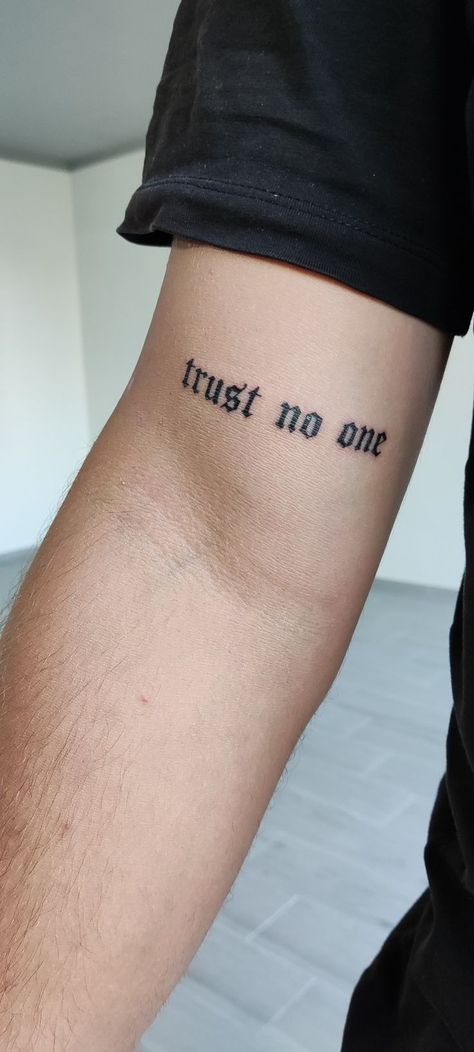 Trust No One Tattoo: Tattoos are a powerful means of self-expression, allowing people to communicate their beliefs, experiences, and philosoph Trust On One Tattoo, Trust No One Tatoos, Trust No One Tattoo Neck, Trust No One Neck Tattoo, Never Trust Tattoo, Don’t Trust Anyone Tattoo, Trust No One Tattoo Ideas For Men, Tato Text, 11 59 Tattoo