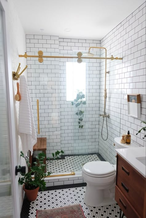 Plant filled white bathroom with a window black and white tile, subway tile and vintage vanity with brass faucet and shower accents Penny Tiles Bathroom, Penny Tile Floors, White Bathroom Tiles, Penny Tile, Boho Bathroom, Upstairs Bathrooms, Small Bathroom Design, Tiny Bathroom, Bathroom Renos