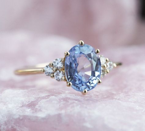 This beautiful ring features gorgeous 1.85 - 2ct unique blue color sapphire. Details Main stone Gemstone: natural sapphire with blue color 1.85 - 2ct Side stones Gemstone: white diamonds, color F - G, VS clarity, total carat weight is 0.18ct, 2mm x6 Band width: approx 1.8 mm Material: 14/18k solid yellow/white/rose gold, platinum Sizes available: 3-8 (Larger and smaller sizes are available as well. Priced upon request.) Procedure information Please select the material and ring size from the drop Lavender Sapphire, Light Blue Sapphire, Blue Sapphire Engagement Ring, Tanzanite Engagement Ring, Cute Engagement Rings, Topaz Engagement Ring, Blue Sapphire Ring, Blue Lavender, Sapphire Engagement Ring Blue