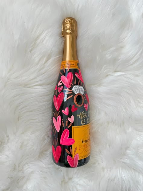 Hen Do House Decorations, Engagement Bottle Decoration, Valentines Aesthetic Decor, Engaged Champagne Bottle, Painted Champagne Bottle Valentines, Champagne Bottle Painting Engagement, Valentines Bottle Ideas, Pink Painted Champagne Bottle, Painted Veuve Bottle Engagement