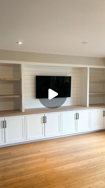 Suits & Sawdust | Custom Woodworking on Instagram: "Living Room Goals 🔥   This built-in entertainment wall made such good use of our client's living room space! It frames their TV beautifully while adding so much additional storage in the wall-to-wall lower cabinets. The white paint brightens the room while adding stained elements like the solid 15 ft countertop and upper shelves in a natural tone, warms the space up providing an extra homey feel 🤩  If you've debated booking a built-in, this is your sign! DM us ❤️ . . . . . . . . . . .  #shiplapwall #shiplapwalls #shiplapfireplace #livingroomstyle #livingroomgoals #livingroommakeover #accentwall #fyp #pov #livingroomideas #beforeandafter #feature wall #hometransformation #goals #storage #storagesolutions #customcabinetry #customwoodworki Long Wall Of Lower Cabinets, Tv Built In Without Fireplace, Living Room Closet Ideas Built Ins, Built In Decor Ideas, Playroom Built In Storage With Tv, Built In Cabinets Below Tv, Built In Shelves Living Room Long Wall, Built In Cabinets With Bookshelves, Built In Wall Unit Dining Room