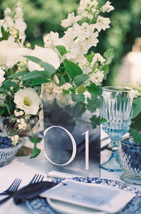 Modern acrylic table number signs paired with blue and white tabletop details. Photo: @sarahharrisphoto Chic Table Numbers Wedding, Navy Blue Table Numbers, Blue Acrylic Table Numbers, Blue And White Table Numbers, Navy Table Numbers, Wedding Table Numbers Blue, Modern Wedding Table Numbers, Blue Table Numbers Wedding, Blue Wedding Signage