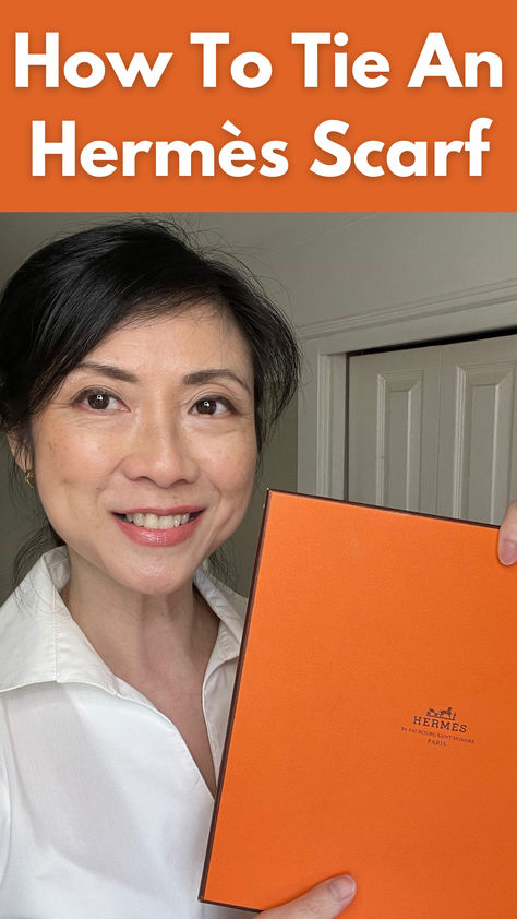 asian woman over 50 holding orange Hermes scarf box. Outfits With Hermes Scarf, How To Tie An Hermes Scarf, European Scarf Outfit, How To Tie Hermes Silk Scarf, How To Tie A French Scarf, How To Wear An Hermes Scarf, Hermes Carre How To Wear, Hermes Scarf 90 Outfit, Tie Hermes Scarf