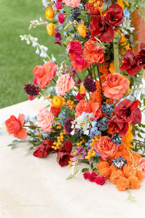 Pink and Orange Wedding Flower Inspiration | The Floral Eclectic My favorite way to add more dimension to an overall warm-colored wedding flower arrangement is to add accents of cooler colors like baby blue and periwinkle. If you’re looking for a similar vibe, pin for inspiration! Red Orange Pink Blue Wedding, Pink Orange Green Wedding Flowers, Sunset Wedding Florals, Orange Pink And Blue Wedding, Red Orange Wedding Theme, Blue Orange Pink Wedding, Fall Colorful Wedding, Red Pink Orange Wedding, Pink Orange Wedding Decor