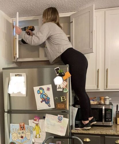 You know those cabinets over your fridge? You know, the ones you can't reach so you just store random stuff in there and forget about it. Or you just keep them empty. Yeah, you know the ones. These: There has been absolutely nothing in these cabinets since we bought this house 2 years ago. SOOOO- Let's take it down, shall we? Step 1: Remove cabinet doors Go ahead and take those useless doors off. We wont be needing them. Step 2: Remove screws Remove all screws that are attaching th… Removing Cabinets From Wall, Taking Doors Off Kitchen Cabinets, Doors Off Kitchen Cabinets, Over Fridge Ideas, Open Shelf Above Fridge, Removing Kitchen Cabinet Doors, Shelves Above Fridge, Cabinets Above Refrigerator, Above Fridge Ideas