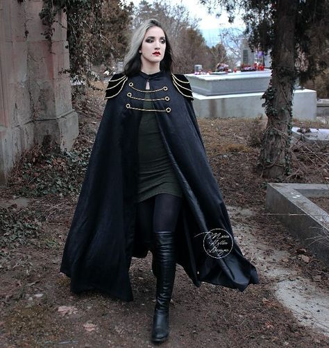 This long black cape is a new addition to my Etsy shop! Link in bio. 💖 It is fully lined and has epaulettes decorated with golden filigrees as well as 3 golden chains in the front. Do you like it? Let me know in the comments!  Cape & model: @maria.heller.designs  #blackcape #longcape #blackcloak #victoriangoth #militarycoat  #gothicstyle #gothstyle #gothicfashion #gothfashion #gothiccape #gothiccloak #gothiccoat #gothcape #gothcloak #gothcoat #blackcloak #witch #militarystyle #gothgirl #gothicg Victorian Cloak, Cape Fantasy, Fantasy Cape, Gothic Cape, Gothic Fashion Victorian, Cape Outfit, Black Cloak, Cape Designs, Black Cape