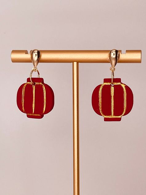 Lunar New Year - Red Lantern Earrings.   Red lanterns are symbols of wealth, prosperity and a thriving life.  Red lanterns are very popular during Chinese New Year.   Red polymer clay with gold mica powder.  Teardrop posts in gold plated brass.  Handmade. Size:  1 1/4 x 3/4 inches Lantern Earrings, Red Lanterns, Red Lantern, Clay Jewellery, Earrings Red, Lunar New Year, Mica Powder, Lunar New, Nouvel An