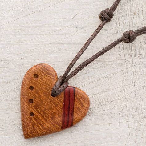 Decorated with a stripe of estoraque wood a heart is hand-carved from madrecacao wood with a beautiful natural grain. Costa Rican artisan Milagro Cascante creates this love-inspired pendant necklace which is decorated with four divots. This necklace circles the neck with an adjustable length of cotton cord. Wood Carved Necklace, Small Wood Crafts, Heart Necklace Diy, Wood Heart Necklace, Wood Necklace Pendant, Wood Jewelry Diy, Wooden Jewelery, Pmc Jewelry, Primitive Wood Crafts