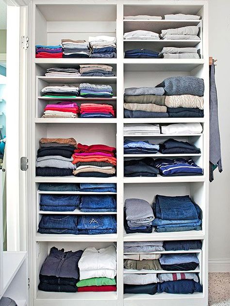 Different heights of shelves offer more flexibility in a master bedroom closet. If you don’t want to fuss with built-in shelves, try dividers that slip into larger spaces -- used here to keep track of thinner T-shirts and other items. Bedroom Closet Shelves, T Shirt Storage, White Shelving Unit, Shirt Storage, Laundry Room Storage Shelves, Clothes Shelves, Folded Clothes, Organizar Closet, Armoire Dressing