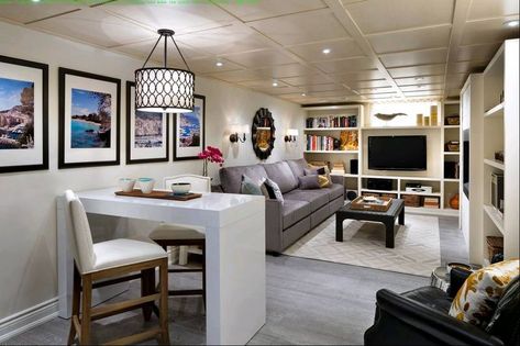 This professionally finished basement now functions as both a retreat and home office, with an abundance of storage solutions. Business Office Interior Design, Narrow Basement, Long Narrow Living Room, Small Basement Remodel, Basement Office, Basement Layout, Narrow Living Room, Basement Living Rooms, Diy Basement