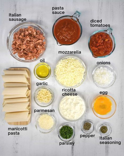 This baked manicotti is stuffed with a three-cheese blend and covered with a delicious Italian sausage tomato sauce. It is easy to make with a combination of fresh and pantry ingredients giving the pasta a homemade taste in a fraction of the time. Stuffed Manicotti With Italian Sausage, Ricotta Manicotti Recipe, Sausage And Ricotta Stuffed Manicotti, Manicotti Freezer Meal, Genuine Italian Recipes, Meat Stuffed Manicotti Recipe Beef, Easy Baked Manicotti, Ground Beef Stuffed Manicotti, Cheese Stuffed Manicotti Easy Recipes