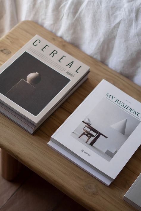 A simple wooden bench provides a surface to display magazines at the end of the bed Simple Wooden Bench, Display Magazines, Coffee Table Book Design, Coffee Table Books Decor, Cereal Magazine, Minimalist Furniture Design, House Styling, Interior Design Books, Ebook Design