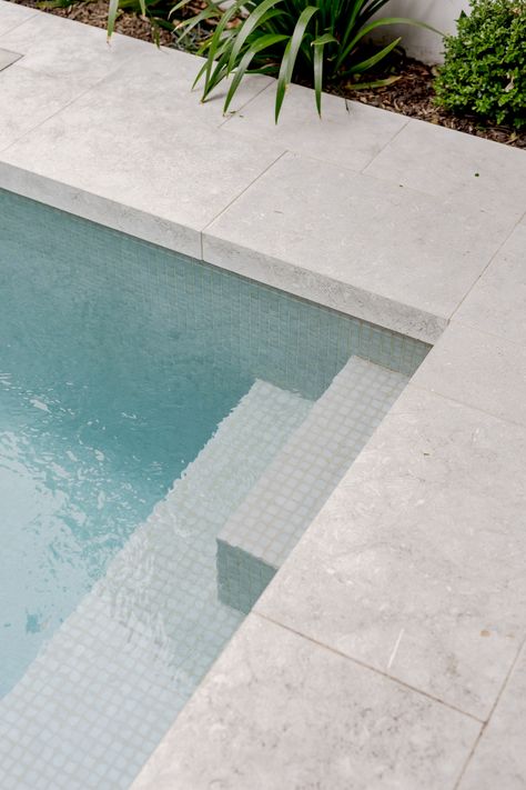 Pools With Stone Walls, Pool Area Flooring, Paving Around Pool Ideas, Concrete Pool Pavers, Pool Limestone Pavers, Pool Edge Tile, Outdoor Pool Tiles, Tiled Pool Steps, Modern Pool Finishes