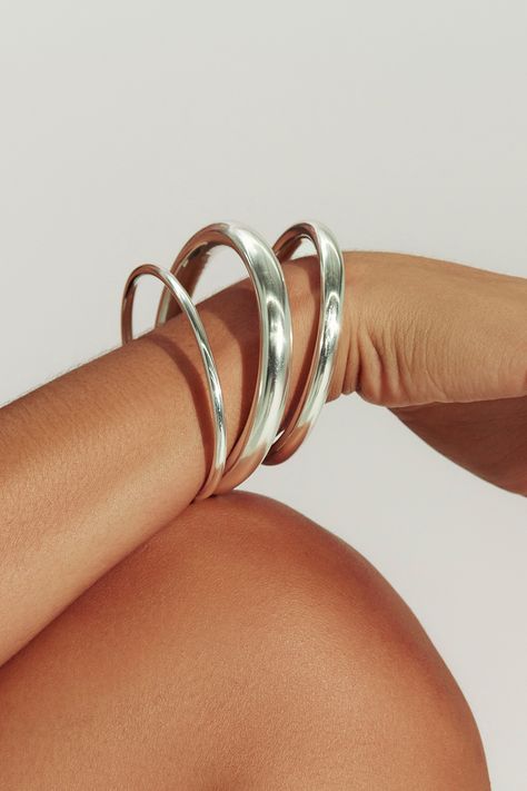 A modern essential, our sterling silver open cuff has the perfect weight and thickness for everyday wear. Layer with our varying widths and finishes for an architectural stack. Jewelry Collection Handcrafted in Brazil Sterling Silver over Brass Thickness: 5.8mm Inner Diameter: 2.5" Opening: 1.25" Weight: 0.36 oz Waterproof Hypoallergenic Funky Silver Jewelry, Silver Everyday Jewelry, Modern Everyday Jewelry, Stacked Jewelry Silver, Big Silver Rings, Dainty Silver Jewelry, Sculptural Bracelet, Stack Jewelry, Silver Bracelet Stack