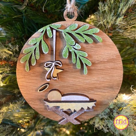 This simple, sweet, beautiful manger scene ornament is a perfect reminder of the true meaning of Christmas.  This ornament is ready to hang and is made of white oak and birch woods. It is hand-painted and slightly distressed for a rustic appeal. Wood Burned Nativity, Diy Manger Ornament, Christian Wood Ornaments, Cricut Nativity Projects, Nutcracker Ornaments Diy, Wecreat Vision, Manger Scene Ornament, Manger Scenes Nativity, Painted Wooden Ornaments