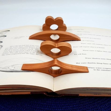 A thumb book page holder that'll ease the annoying task of constantly adjusting the moving pages while reading. No more creasing pages and the holder can be personalized! Book Buddy, Thumb Book, Page Holder, Wooden Things, Unique Bookmark, Book Holder, Wood Book, Wooden Books, Wood Working Gifts