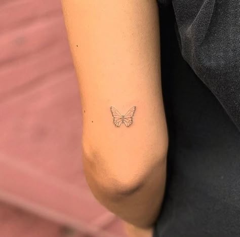 Butterfly tattoo on the back of the arm. #tattooideas #tattoos #butterflytattoos Butterfly Tattoo Above Elbow, Tattoo Above Elbow, Tattoo Papillon, Above Elbow Tattoo, Tiny Butterfly Tattoo, Tattoo On The Back, Small Back Tattoos, Small Butterfly Tattoo, Butterfly Tattoos For Women