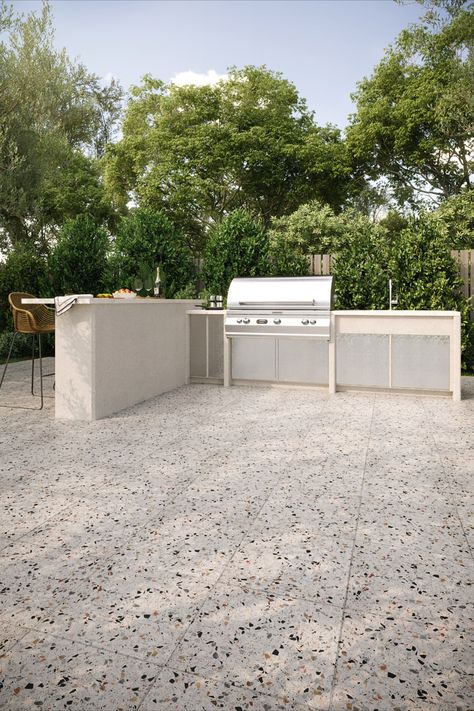 Outdoor kitchen space with terrazzo stone floor tile. Outdoor kitchen is complete with island, bar stools, and grill. Terrazzo Exterior Floor, Terrazzo Balcony Floor, Terazzo Floor Garden, Terrazzo Tiles Outdoor, Terrazo Flooring Patio, Terrazzo Patio Floor, Terazzo Outdoors, Terrazzo Pool Deck, Terrazzo Porch