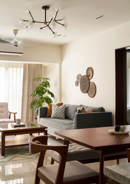 Modern Indian Apartment Interiors, Living Room Inspo Indian, Theme For Interior Design, Minimalist Indian Living Room, Singapore Living Room Design, Mumbai House Interior, Orange Beige Living Room, Mumbai Interior Design, Dining Lounge Room