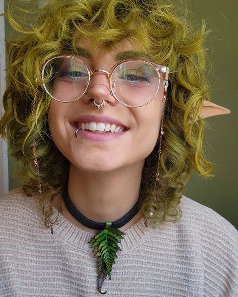 Fairycore witch forest hair green curly piercing septum lip glasses moss wolfcut layers Short Curly Green Hair, Shane Haircut, Fairy Hair Color Ideas, Short Fantasy Hair, Goblincore Hairstyles, Green Hair Curly, Goblincore Hair, Curly Punk Hair, Curly Green Hair