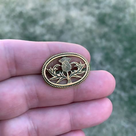 Small Scottish Thistle Pin - Bronze | Scottish Kilt Brooches / Pins. The Thistle is the national flower and has become the premier symbol of Scotland. Pendant: BronzeApprox. Size: 1.125" (2.9cm) wide x 0.75" (1.9cm) tall. Worldwide shipping available!US Customers: Typically ships in 1 business day, delivers in 2-5 days.Outside of US: See shipping options during checkout. Share this item: Scottish Accessories, Scottish Poems, Viking Brooch, Thistle Jewellery, Cloak Clasp, Thistle Tattoo, Scottish Jewelry, Thistle Wedding, Thistle Design