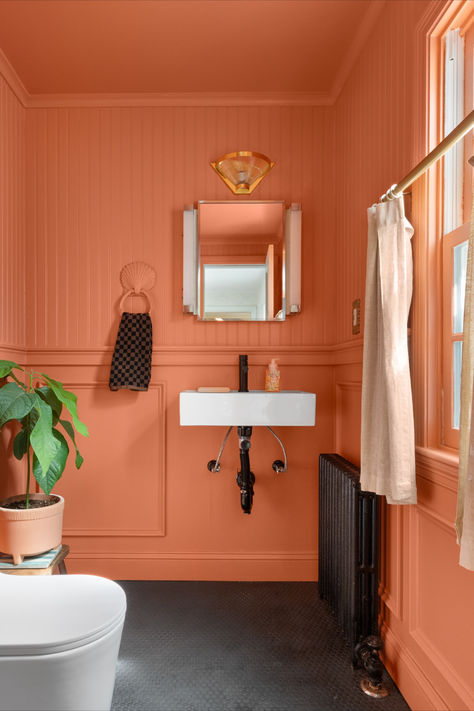 See inside illustrator and fabric designer Faye Hurley’s home that’s packed with charming details in every single room. Coral Panelling, Coral Wall Paint, Jungalow Bathroom, Eclectic Maximalist Bedroom, Maximalist Bedrooms, Coral Bathroom, Massachusetts Home, Painted Bathroom, Coral Walls