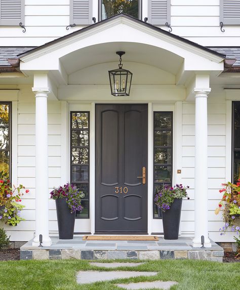 These striking, yet timeless hues prove your front door doesn't need to be bright to be bold. Whether your style is crisp and tailored or breezy and relaxed, these ideas for dark front door colors will give your home an entirely new look. #homeideas #frontdoorideas #curbappeal #frontdoorpaintideas #bhg Dark Front Door, Residential Front Doors, Grey Front Door, Black Front Door, Farmhouse Chandeliers, Black Front Doors, Exterior House Color, Door Paint Colors, Painted Front Doors