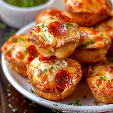 Discover a delightful twist on traditional pizza with these Easy Cheesy Pepperoni Pizza Puffs. Packed with gooey cheeses, savory pepperoni, and a blend of herbs, these bite-sized muffins are perfect for any occasion, from snacks ... READ MORE Pepperoni Appetizers, Pepperoni Bites, Pepperoni Pizza Puffs, Pizza Puffs, Pepperoni Pizza Bites, Mini Pizza Bites, Pepperoni Recipes, Pizza Roll Recipe, Leftover Pizza