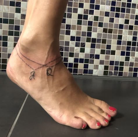 Anklet tattoo with letters | Anklet tattoos, Bracelet tattoos with names, Ankle bracelet tattoo Beach Anklet Tattoo, Tattoo With Letters, Unique Tattoos For Moms With Kids, Charm Anklet Tattoo, Heel Tattoo, Bracelet Tattoos With Names, Ankle Tats, Anklet Tattoos For Women, Charm Bracelet Tattoo