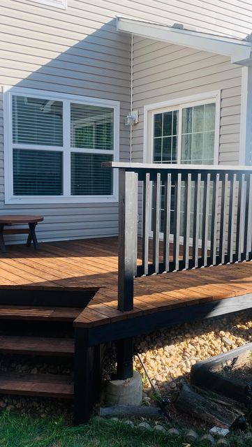 Brenda | DIY & Design on a budget | Latina on Instagram: "Deck Makeover 🖤 ✨  This 22 year old deck needed a refresh so bad and I didn’t love the cedar stain so nothing a fresh coat of new stain can’t fix!!   I used deck stripper and a power washer to strip off the floor stain completely and used @olympicstains on these colors:  Floors: Canyon Brown (one coat) Banister: Black (Behr’s tone-two coats)   Details in my highlights ✨  #thepowerofpaint #buildergradeupgrade #olympicstain #homedepotdeckp Two Tone Stained Deck, Deck Colors For Red Brick House, Front Porch Stain Ideas, Black Stained Deck, Two Tone Deck Color Ideas, Deck Painting Ideas, Black Porch, Cedar Stain, Deck Makeover