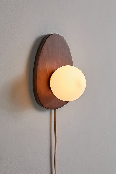 Refresh your lighting display with this statement sconce featuring a sculptural wood base topped with a milky glass shade. Plugs in to power on. Available exclusively at Urban Outfitters. Features Statement sconce from our Yoji lighting collection Sculptural base Milky glass shade Plug in UO exclusive Content + Care Wood, iron Wipe clean Imported Made in compliance with US electrical standards. To use this item outside of the US, pair with an outlet adapter and voltage converter made specifically for use in your location. Size Wattage/Voltage: AC 120V/60Hz Overall dimensions: 11.3" l x 7.4" w x 6.5" h | Yoji Sconce in Brown at Urban Outfitters Luminaria Diy, Plug In Wall Lamp, Plug In Pendant Light, Retro Lampe, Minimalist Lighting, Wall Sconces Bedroom, Sconces Bedroom, Age 50, Organic Forms