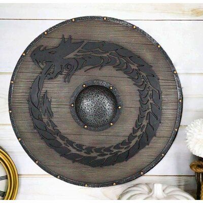 This Dragon Fire Wheel Viking Shield Wall Decor is approximately 12.5" in diameter and 1" thick. It weighs about 3 pounds. | Trinx Dragon Symbol Wall Decor in Brown, Size 12.5 H x 12.5 W x 1.0 D in | Wayfair | Home Decor Dragon Symbol, Warrior Shield, Shield Wall, Viking Decor, Viking Dragon, Dragon Fire, Viking Shield, Gift Catalog, Nature Wall Decor