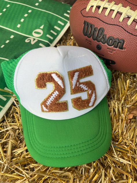 The perfect hat to cheer on your favorite football player. Pick your team’s colors and your player’s jersey number and show your support. 

The trucker mesh hat is a great fit for everyone and the ideal accessory to keep the sun out of your eyes during the game. This is a must-have for all footbal fans.

All hats are made-to-order. Football Numbers, Mom Accessories, Custom Football, Mesh Hat, Football Mom, Football Player, Team Colors, Football Players, Sports Team