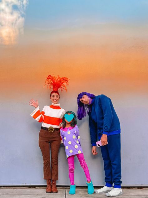 Family wearing Inside Out 2 costumes in front of ombre wall Inside Out Anxianity Costume, Inside Out 2 Costumes Group, Inside Out 2 Costume, Ennui Costume, Envy Costume, Inside Out Halloween, Inside Out Costume, Movie Character Costumes, Diy Couples Costumes