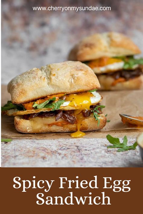 Start the day the best possible way, with this spicy fried egg sandwich topped with caramelized onions, cheddar, and a special spicy sauce. #breakfastsandwich #eggsandwich #eggs #brunchideas #breakfastrecipe #sandwichrecipe #vegetarianbreakfast Egg Benedict Sandwich, Spicy Egg Sandwich, Ciabatta Egg Sandwich, Ciabatta Sandwich Recipes Breakfast, Special Sandwich Ideas, Turkey Bacon Egg Sandwich, Sauce For Breakfast Sandwich, Deviled Egg Sandwich, Fried Egg Breakfast Ideas