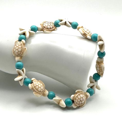 Step into a world of maritime wonder with my latest creation - the Stone Sea Turtle and White Star Fish Anklet Bracelet. Immerse yourself in the serene beauty of the ocean as you adorn your anklet with this beautiful piece. Crafted with sea turtle, star fish, and turquoise round beads. This bracelet is a symbol of both elegance and tranquility. Anklet diameter is approximately 7 1/2 inches. It can be made to other sizes, just contact me. :) Ideal Uses/Occasions: * Perfect for adding a touch of y Sea Bracelet, Sea Turtle Jewelry, Beach Themed Crafts, Sea Turtle Bracelet, Turtle Jewelry, Turtle Bracelet, Bracelet Stone, Gelang Manik, Star Fish