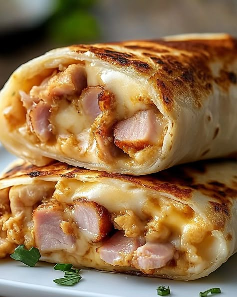 🥪 Air Fryer & Oven Hot Chicken Ham and Cheese Wraps 🧀 A warm, crispy wrap filled with savory Black Forest Chicken ham and Swiss cheese, perfect for a quick snack or lunch! These wraps can be made in both the air fryer or oven for a delicious, melty treat. 🥄 Ingredients • 4 (8-inch) tortillas • 8 slices Black Forest Chicken ham • 2 tbsp mayonnaise • 4 tsp Dijon mustard • 1 tbsp butter, melted • 4 slices Swiss cheese 🔥 Air Fryer Instructions 1. Warm Tortillas: - Place tortillas on... Cheese Wraps Recipes, Wrap Fillings Ideas, Ham And Cheese Tortilla, Ham And Cheese Wraps, Chicken Ham And Swiss, Chicken Ham And Cheese, Cheese Air Fryer, Cheese Wraps, Lunch Sandwiches