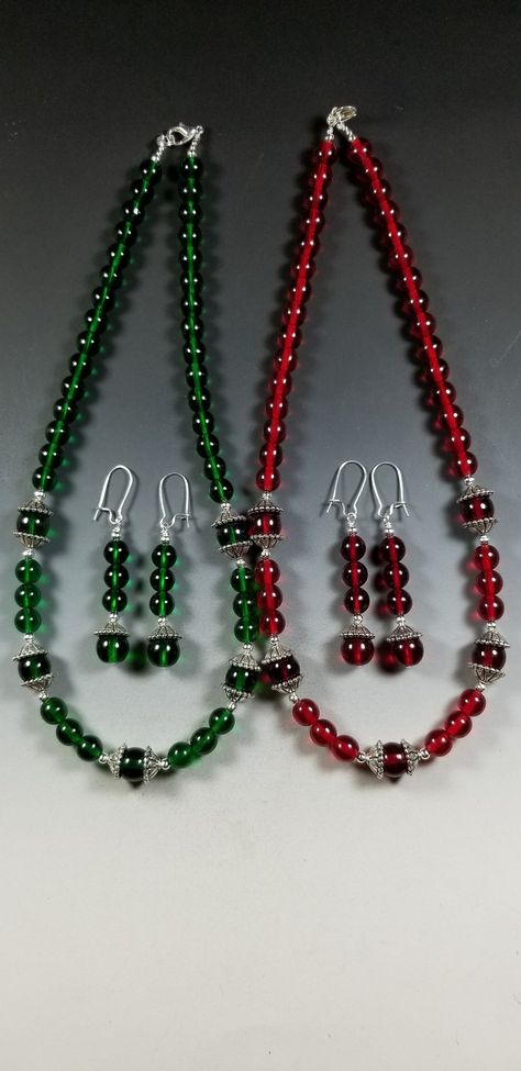 This pretty Necklace and Earrings set is available in your Choice of Emerald Green or Ruby Red.   The necklace is made with 8mm Translucent Czech Glass Beads highlighted with 10mm beads surrounded with Tibetan Silver Bead Caps. The overall length is 18 inches. It's strung on heavy duty tiger tail for strength and is finished off with a silver plated Lobster Claw clasp and Jump Ring. The matching earrings are 1-3/4 inches long ( not including the silver plated kidney shaped ear wires) and are lig Tiger Tail, Czech Glass Necklace, Genuine Pearl Necklace, Stone Bead Jewelry, Heart Necklaces, Beaded Earrings Diy, Pretty Necklace, Glass Beads Jewelry, Bead Necklaces