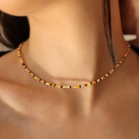 Black orange and white seed bead choker necklace    ≫ PRODUCT DETAILS:    🎃  MATERIAL:    * Glass Czech Seed Bead - 3 mm   * Lobster claw   * Chain extended length - 2 inches  🎃  SIZING GUIDELINES:    * 14 inch (36 cm)    * 16 inch (40 cm)    * 20 inch (50 cm)    * 24 (60 cm)    * 30 inch (76 cm)     ★ Your necklace will be packaged in a custom JuJuJewelryStudio recyclable cardboard box!       * IMPORTANT:    Adult supervision is recommended for kid necklace. Small parts may present a choking Autumn Seed Bead Necklace, Seed Bead Choker, Bead Choker Necklace, White Beaded Necklaces, Halloween Necklace, Bead Choker, Kids Necklace, Beaded Choker Necklace, Themed Jewelry