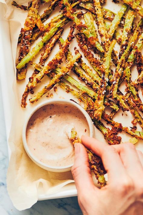 Hand dipping broccoli fry into a bowl of vegan dijon aioli Fried Broccoli Stems, Broccoli Stems Air Fryer, Brocolli Stalk Recipe, Broccoli Stalk Fries, Brocolli Stems Recipe, Broccoli Fries Recipe, Broccoli Fries Air Fryer, Broccoli Stem Fries, Broccoli Stalk Recipes