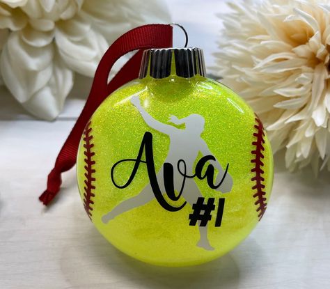 "Personalized shatterproof softball pitcher ornament with your choice of name, jersey number & date topped with a red grosgrain ribbon for hanging ♥️ This is a disk style ornament.  I do offer traditional round ornaments in different styles in my Etsy shop ♥️ Size: 80mm (approximately 3\" in diameter) As always, all of my creations are made in my private studio which is sanitized regularly throughout the day ♥️ My private studio is a completely smoke and pet free environment ♥️" Softball Christmas Party, Softball Christmas Gifts, Softball Treats, Softball Christmas Ornaments, Softball Sign, Softball Decorations, Softball Ornaments, Softball Christmas, Softball Photography