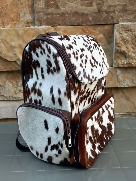 Planning your travel without this backpack? Real cowhide Genuine leather Outer large pockets + feeder pocket Inner pockets Padded leather shoulder straps fastening zippers Spacious and durable Ideal for daily backpack, school college backpack, laptop bag, diaper bag, travel backpack etc Dimensions: 12″L X 14″H X 6″W The Pictures in the listing is for reference only. Each cowhide is unique in its color and texture. The bag you'll receive will be similar in color and texture with the picture shown Dipper Bag, Cowhide Backpack, Bag Picture, Daily Backpack, Baby Clothes Country, Best Travel Bags, Diaper Bag Essentials, Western Bag, Cowgirl Accessories