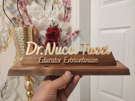 Our product is specially designed and handmade. The wooden table name holder is carefully made from various trees. Personalized table name plate will be the most beautiful decoration of your table with its different and special design. Our products are made of natural wood. In this product, the name parts are made of poplar wood and the pedestal on which the names sit is made of walnut wood. The ground is made of pine or similar trees. approx size: length: 28cm height: 6.75 cm Name Board Design, Table Name Holders, Natural Wood Desk, Custom Desk Name Plates, Doctor Lawyer, Lawyer Office Decor, Name Holder, Personalized Desk Name Plate, Office Desk Name Plates