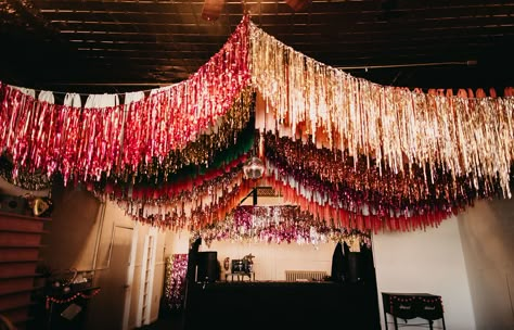 Have you ever wondered what it would be like to get married on Leap Day? Well this whimsical and unique day is perfect inspiration! From the sequin bridal gown and colorful bridesmaids dresses, to the disco balls, confetti and ceiling streamers, it's one big colorful party! Best part? The bride and groom tackled so many wedding DIY projects and pulled them all off! #gws #discowedding #greenweddingshoes #diywedding #whimsicalwedding #funwedding Party Decor Ceiling, Streamer Wedding Decorations, Fringe Wedding Decor, 70s Inspired Party Decor, Diy Ceiling Fringe, Ceiling Streamer Decorations, Avant Garde Wedding Decor, Fringe Ceiling Decor, Disco Party Diy