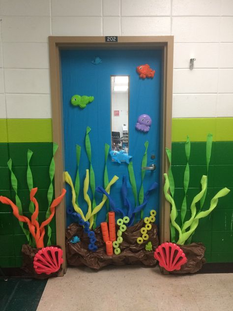 Under the Sea classroom door with pool noodles and dollar tree beach toys. Under The Water Theme Classroom, Starfish Door Decorations Classroom, Water Theme Classroom Decor, Octopus Classroom Door, Under Sea Classroom Theme, Under The Sea Preschool Classroom, Sea Animal Decorations, Under The Sea Door Theme, Sea Themed Decorations