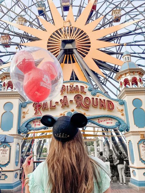 A girl stands with a Mickey ballon, Mickey ears, with her back turned away from the camera. She stands in front of the entrance to Pixar pier, which has the words “Pixar Pal-A-Round” Disneyland Couples Pictures, Disney Land Pictures, Disney Poses, Pixar Pier, Disneyland Photography, California Pictures, Aesthetic Disney, Adventure Picture, Disneyland California Adventure