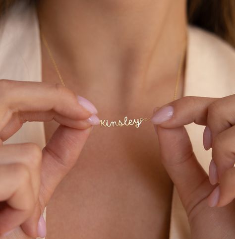 "D A I N T Y ∙ N A M E ∙ N E C K L A C E Discover our Dainty Personalized Name Necklace, a truly one-of-a-kind piece. It's the perfect gift, whether it's for yourself or your special someone! * Material: High Quality Solid 925 Sterling Silver  * Dimensions: Depending on your font choice, height sizes range from 3mm to 4mm lowercase. * Finish: Sterling Silver ∙ 18K Gold ∙ Rose Gold  ♡ Model showcases a fashionable layering look featuring:  * Dainty Mirror Chain: https://etsy.me/3RnmrAr * Pave Linked Pendant Necklace: https://etsy.me/47yBwET * Birthstone Hoop Earrings: https://etsy.me/48ivLf6 * All our jewelry is custom made by hand with Love and Care in our workshop ♡ H O W ∙ T O ∙ O R D E R  * Simply use the 'PERSONALIZATION BOX' to let us know the NAME and the FONT NUMBER that you would l Initial Tag Necklace, Romantic Christmas Gifts, Handwriting Bracelet, Fingerprint Necklace, Sideways Initial Necklace, Dainty Initial Necklace, Diamond Huggies, Cursive Font, Name Jewelry