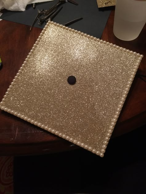 Graduation cap. Gold glitter pearls simple Black Glitter Graduation Cap, Pearl Graduation Cap Ideas, Graduation Cap Designs With Pearls, Gold Grad Cap Ideas, Gold Graduation Cap Designs, Pearls Graduation Cap, Simple Cute Grad Caps, Grad Cap With Pearls, Graduation Cap With Pearls